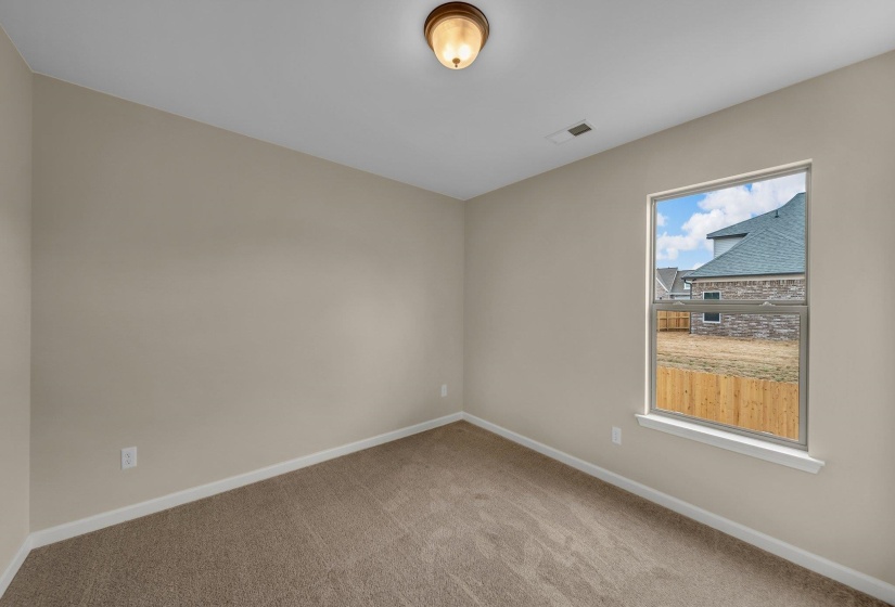 Carpeted spare room featuring baseboards and visible vents