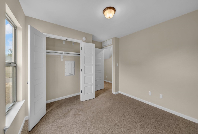 Unfurnished bedroom featuring baseboards, carpet flooring, and a closet