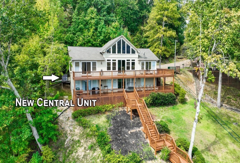 Rear view of house with stairs and a deck with water view