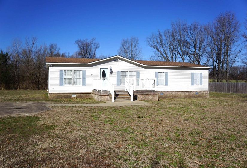 Manufactured / mobile home featuring crawl space, fence, and a front lawn