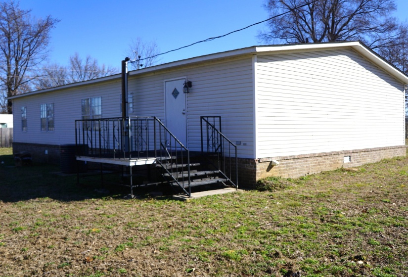 Rear view of property with crawl space and a lawn