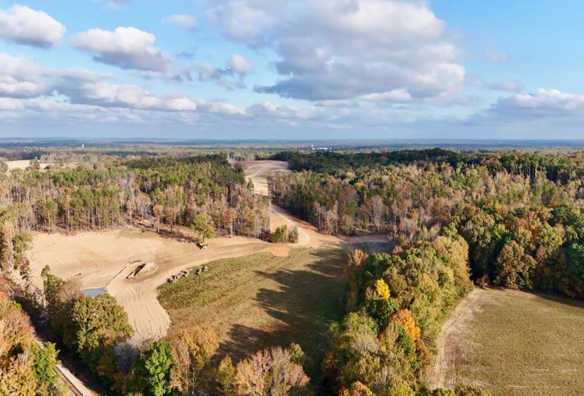 Birds eye view of property featuring a wooded view