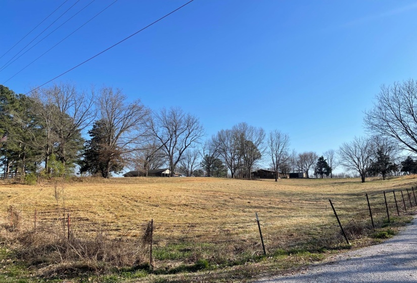View of yard with a rural view and fence