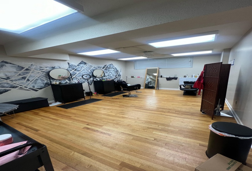 Workout room with wood finished floors and baseboards
