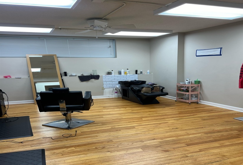 Office featuring baseboards, light wood-type flooring, and ceiling fan