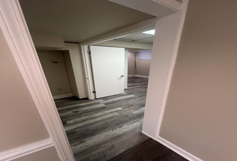 Corridor with wood finished floors and baseboards