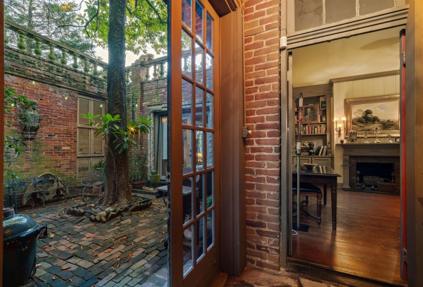 Doorway featuring wood-type flooring and exterior fireplace