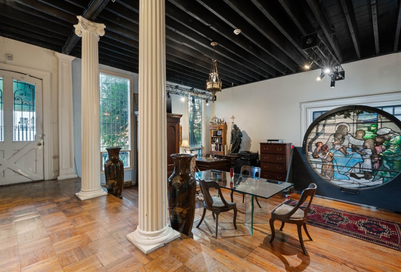 Foyer entrance with parquet flooring and ornate columns