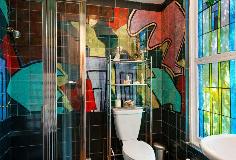 Bathroom with toilet and tile walls