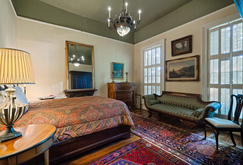 Bedroom with a notable chandelier and wood-type flooring