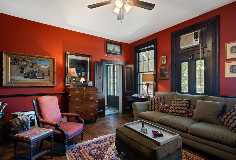 Living room featuring french doors, ceiling fan, and an AC wall unit