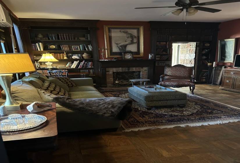 Living room featuring ceiling fan and parquet flooring