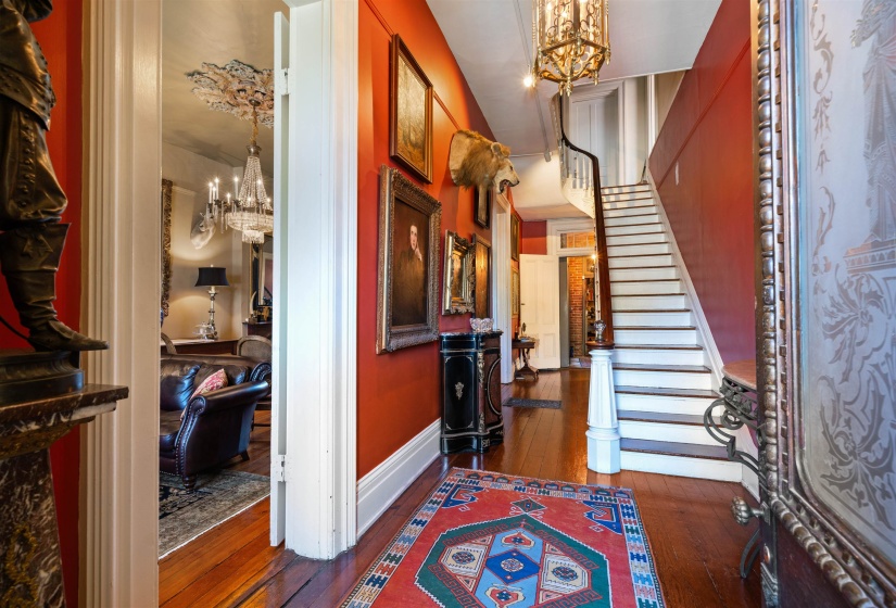Entrance foyer featuring an inviting chandelier and dark hardwood / wood-style flooring