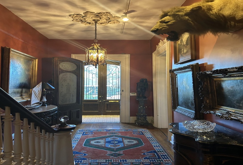 Entrance foyer with french doors and an inviting chandelier