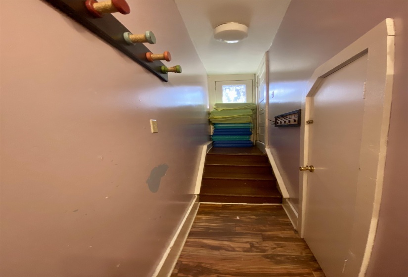 Staircase with baseboards and wood finished floors