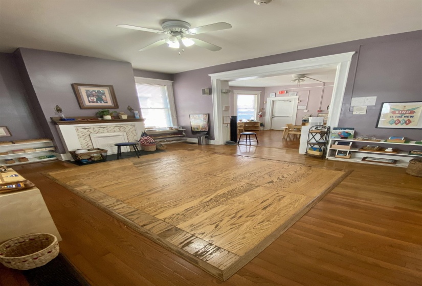 Living area with wood finished floors and a ceiling fan
