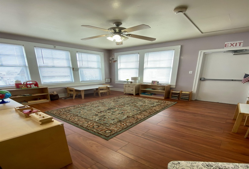 Living area featuring wood finished floors and a ceiling fan