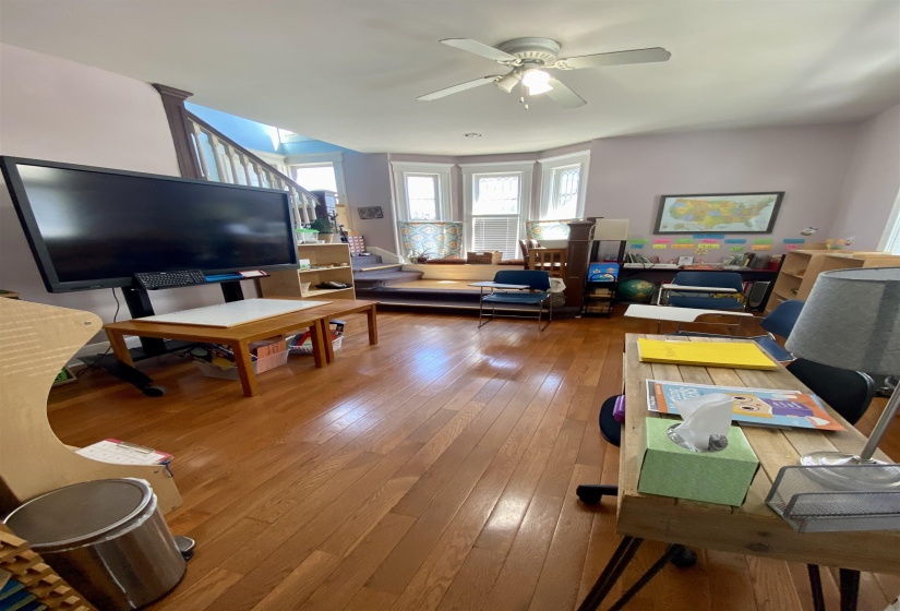 Living area featuring ceiling fan and wood-type flooring