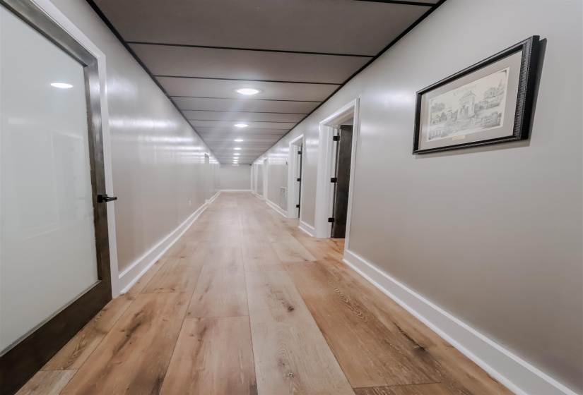 Corridor featuring baseboards and light wood-type flooring