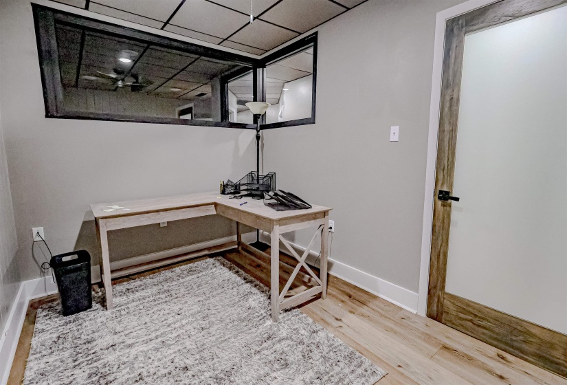 Office area with baseboards and wood finished floors
