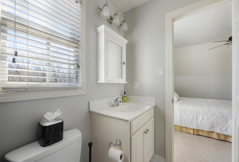 Bathroom with a ceiling fan, toilet, and vanity