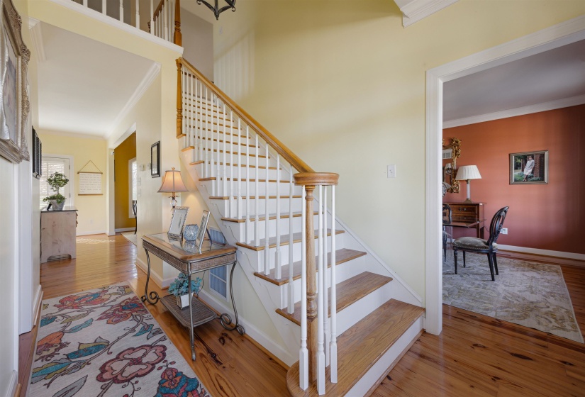 Stairway featuring crown molding, baseboards, and wood finished floors