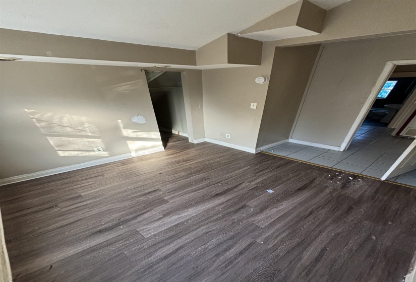Interior space with baseboards and wood finished floors