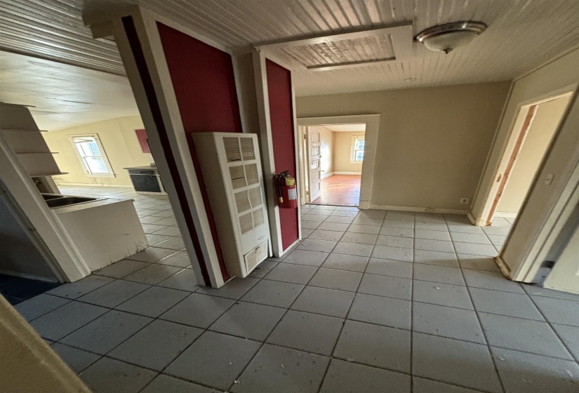 Hall featuring tile patterned floors and a heating unit