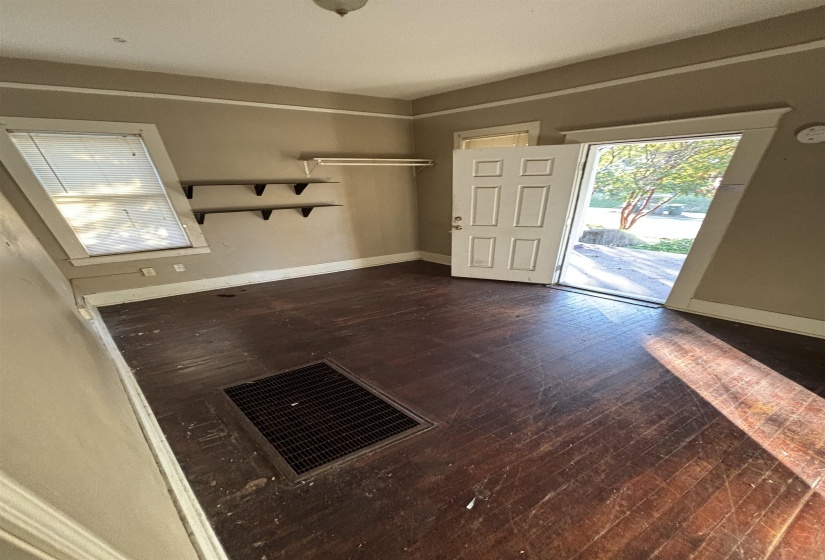 Entryway with dark wood-style floors, baseboards, and visible vents