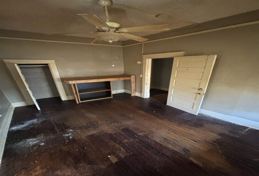 Unfurnished living room with baseboards, ceiling fan, and wood finished floors