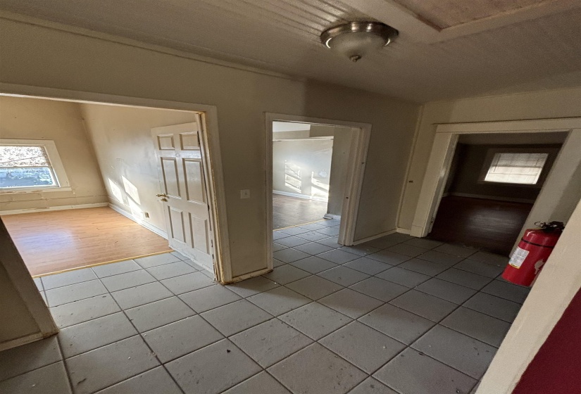 Hallway with light tile patterned floors and baseboards