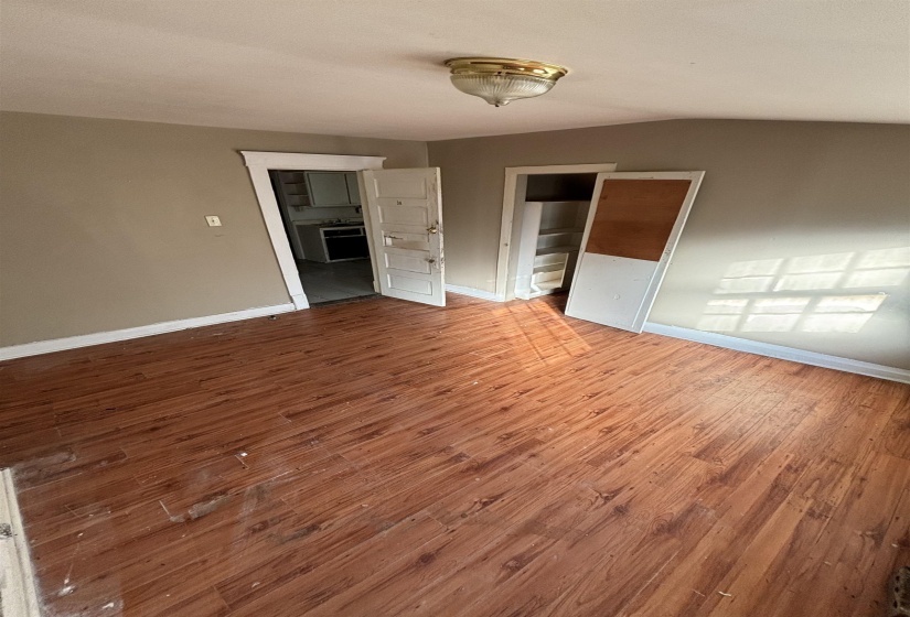Interior space featuring baseboards and wood finished floors