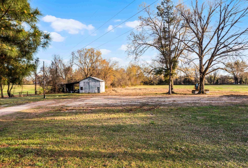 View of yard with an outbuilding and a pole building