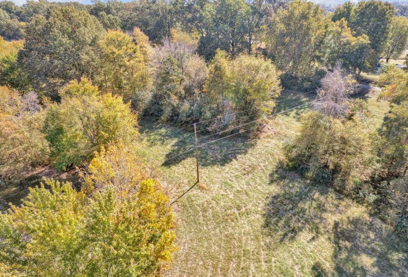 Birds eye view of property with a wooded view