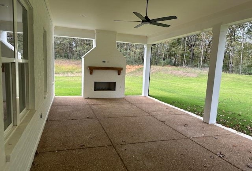 View of patio / terrace featuring exterior fireplace and ceiling fan
