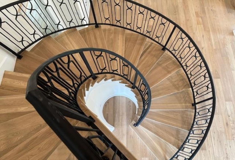 Stairway featuring hardwood / wood-style floors