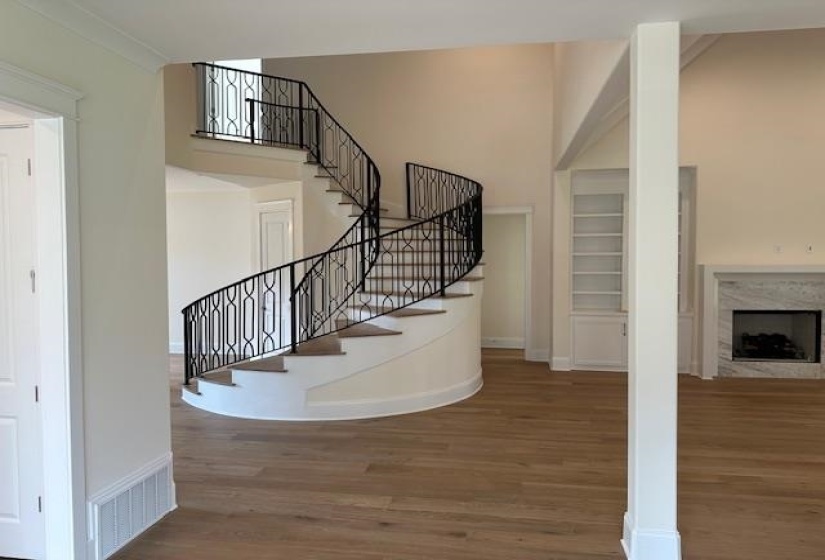 Stairs with hardwood / wood-style floors and crown molding