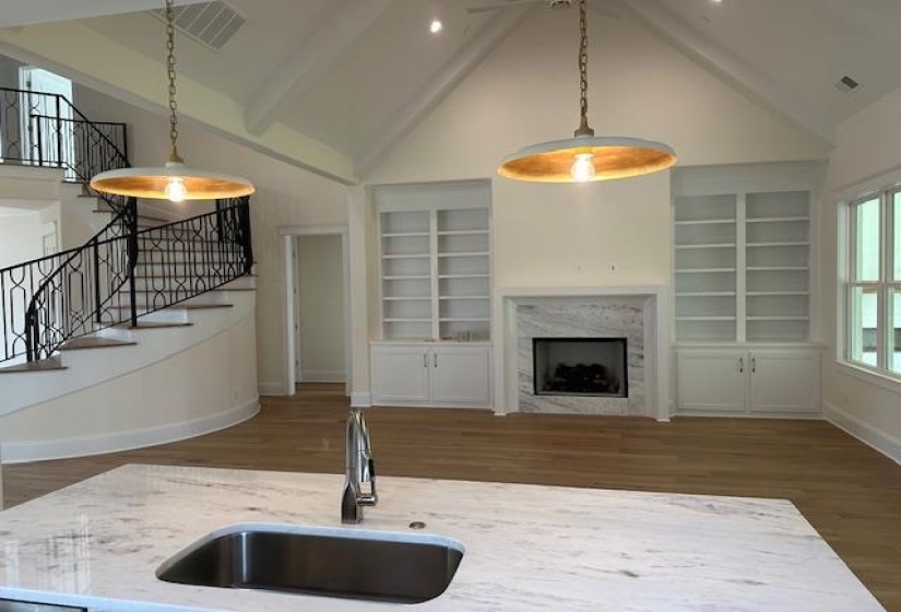 Kitchen featuring dark hardwood / wood-style flooring, sink, decorative light fixtures, high vaulted ceiling, and beamed ceiling
