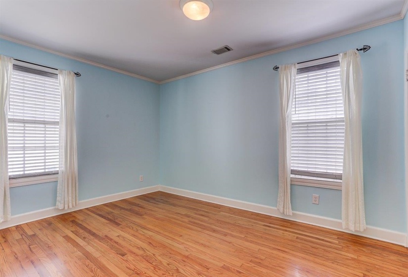 Unfurnished room featuring crown molding and light wood-type flooring