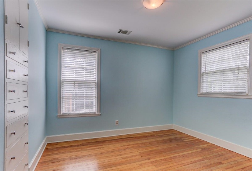 Unfurnished bedroom featuring light wood finished floors and ornamental molding