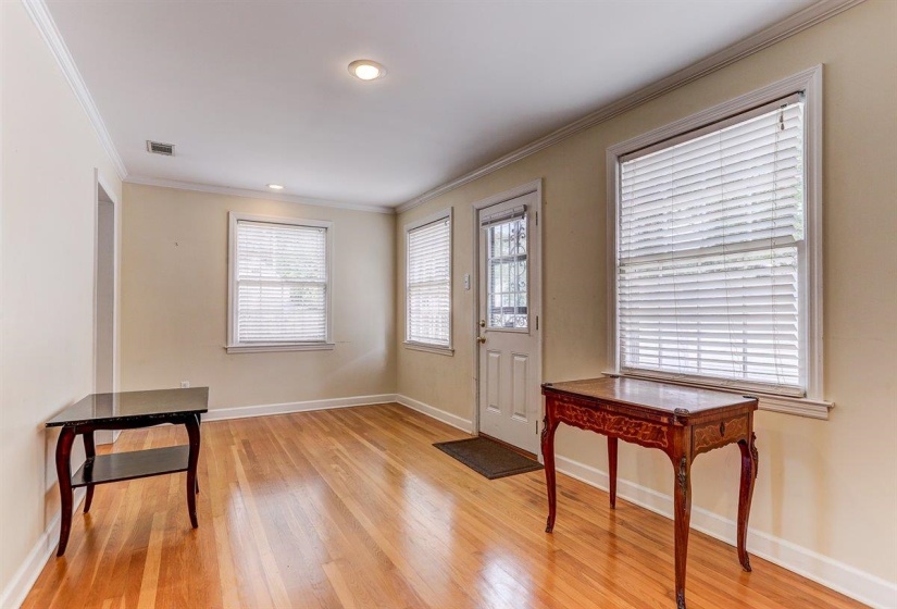 Foyer featuring crown molding and light wood-type flooring