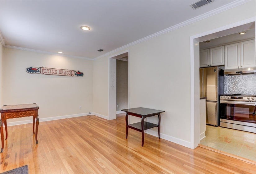 Interior space featuring crown molding, recessed lighting, and light wood finished floors