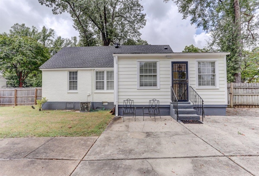 View of front of property featuring roof with shingles, a patio, entry steps, and brick siding