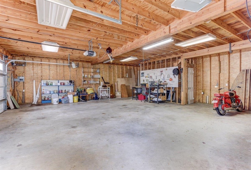 Garage with a workshop area and a garage door opener