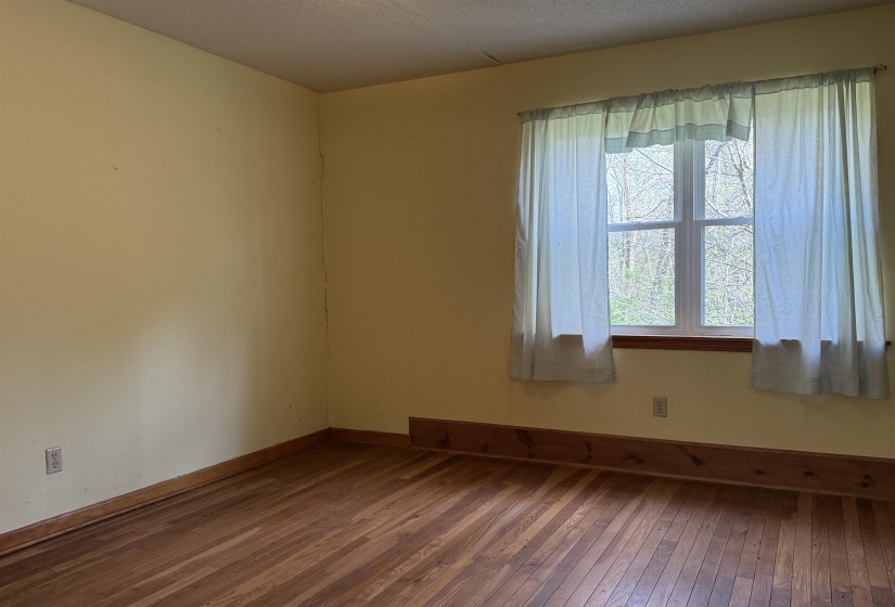Empty room featuring hardwood / wood-style floors and baseboards