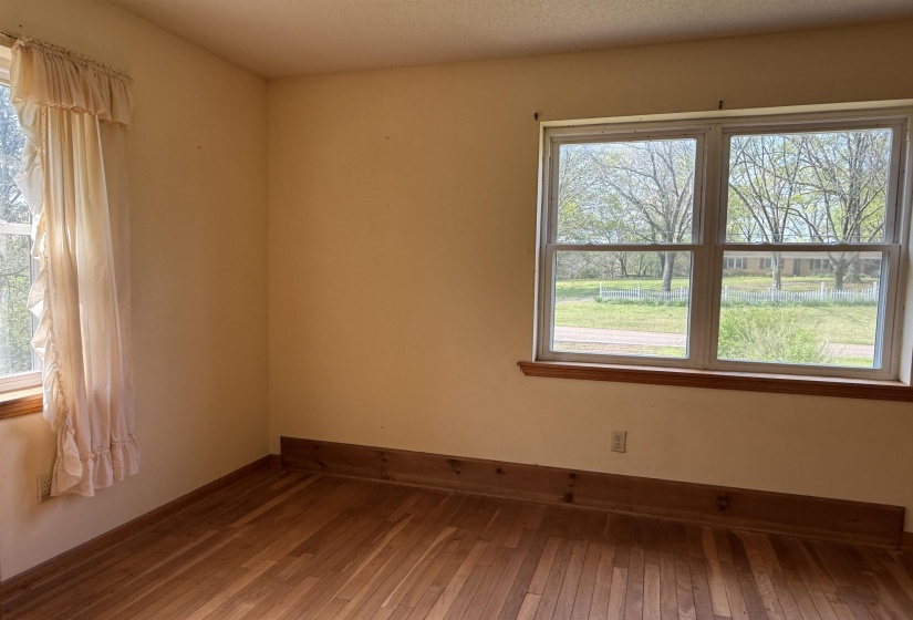 Unfurnished room with baseboards and wood-type flooring