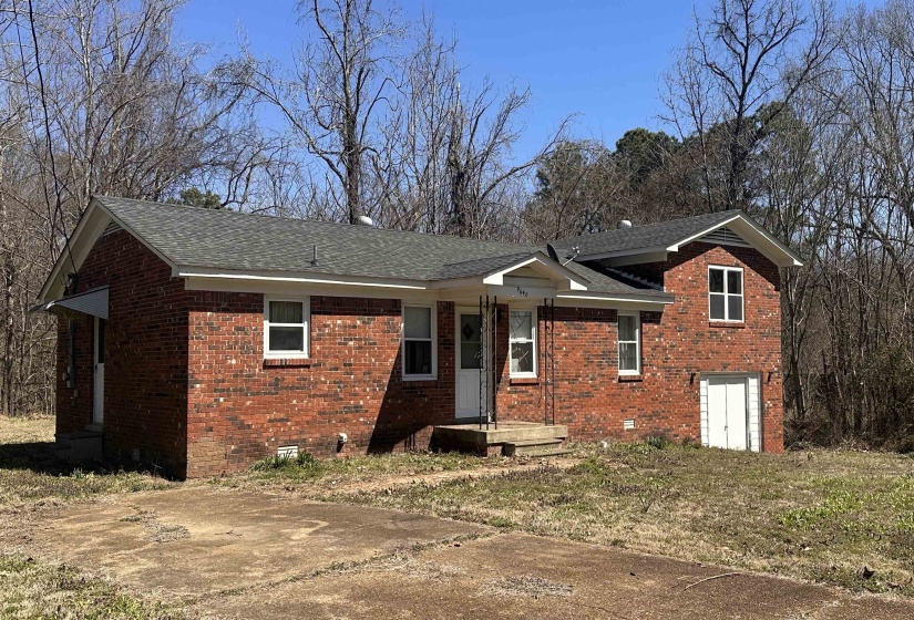 Split level home featuring brick siding, crawl space, and a shingled roof
