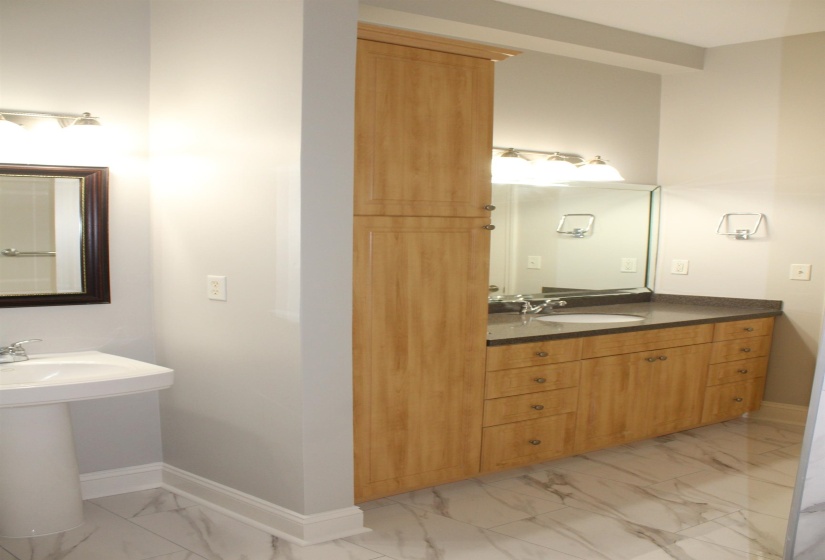 Bathroom featuring marble finish floor, baseboards, and a sink