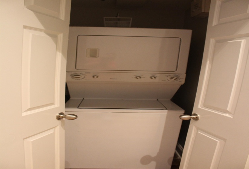 Laundry area with laundry area and stacked washer / drying machine