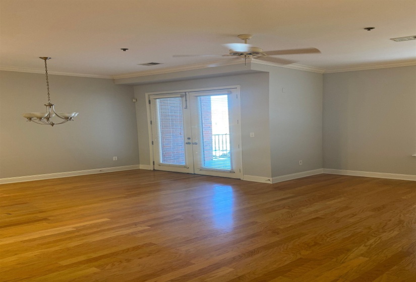 Unfurnished room featuring french doors, visible vents, crown molding, and light wood-type flooring